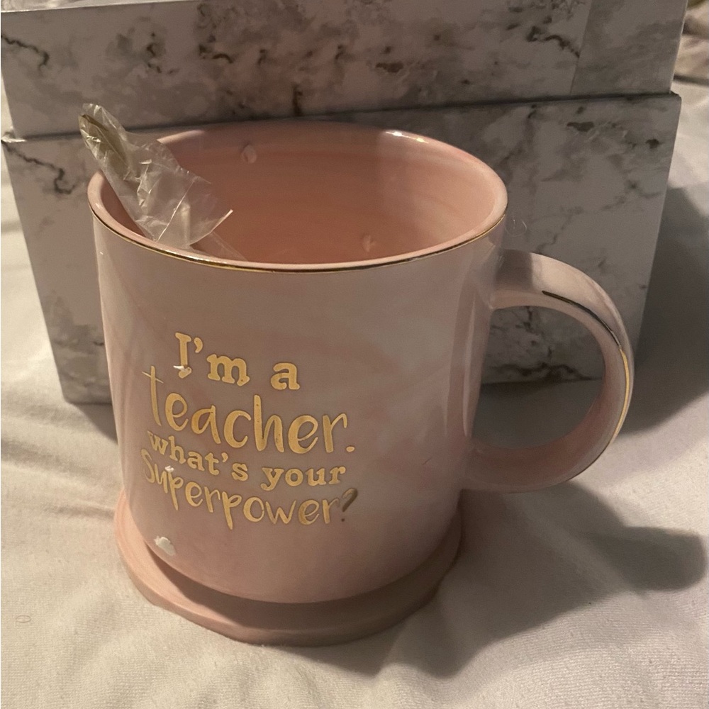 Coffee /tea cup with a coaster and spoon